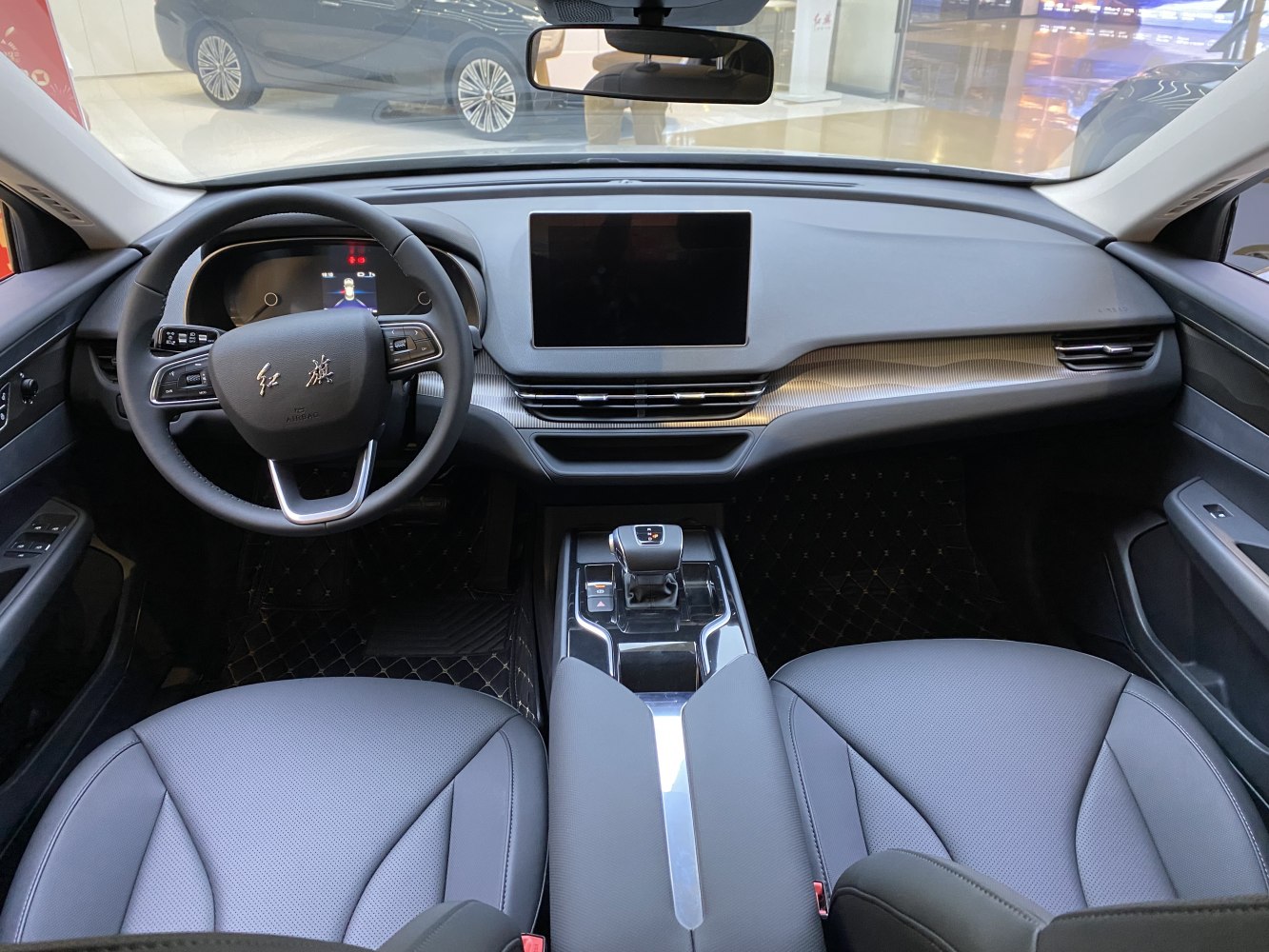 Digital dashboard, touchscreen, and steering wheel controls in a modern car interior