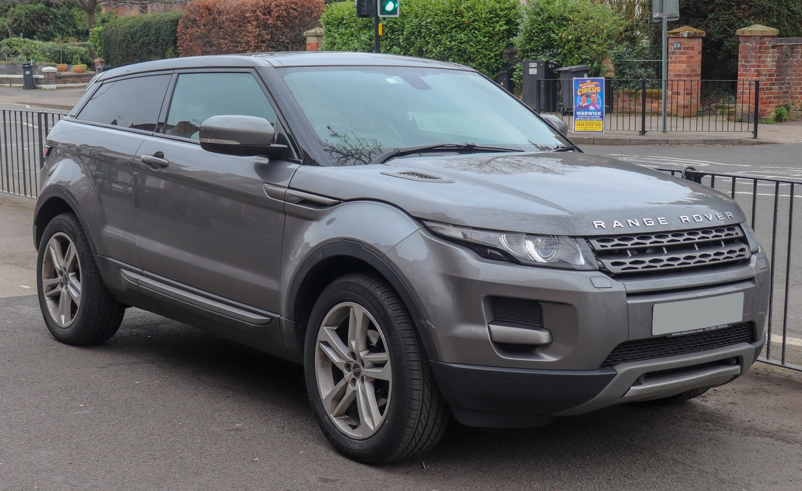 Front-side view of gray 2011 SUV showing headlight and grille design