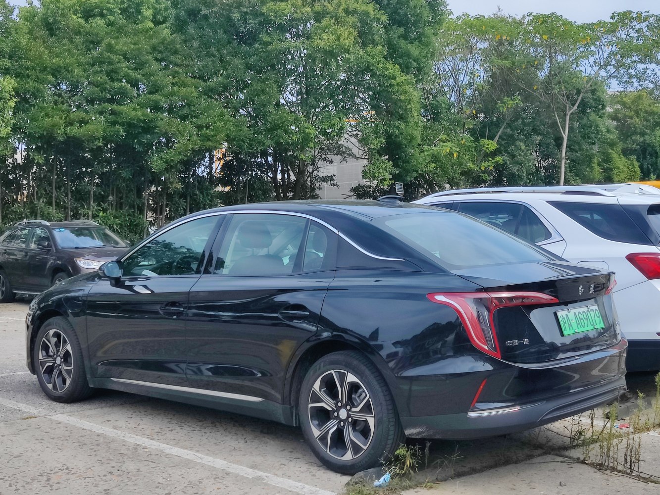 Sleek black sedan rear side with LED taillights and alloy wheels