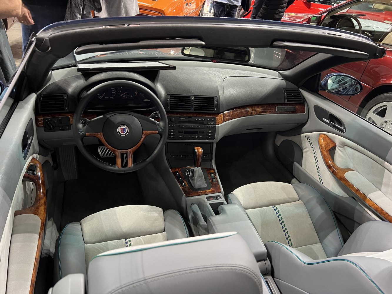Convertible interior with wood trim, leather seats, and classic dashboard layout