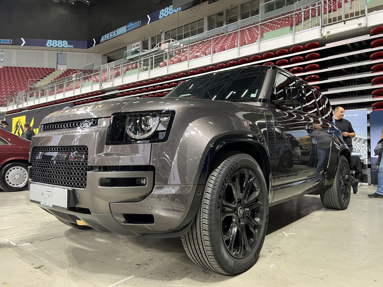 Front view of an SUV with black alloy wheels and bold grille