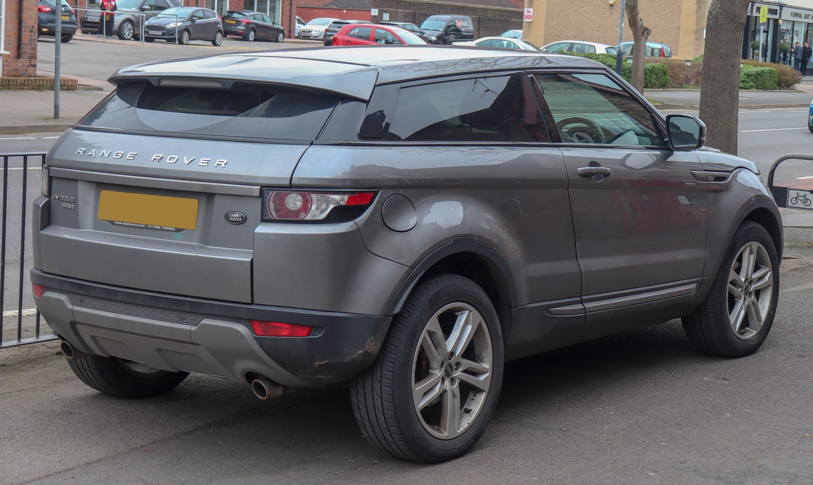Rear-side view of a sporty compact SUV with tinted windows and alloy wheels.