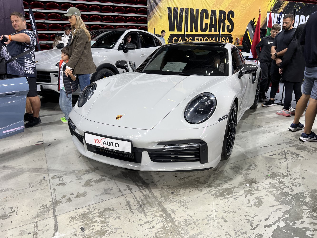 Front view of white sports coupe with round headlights and black trim