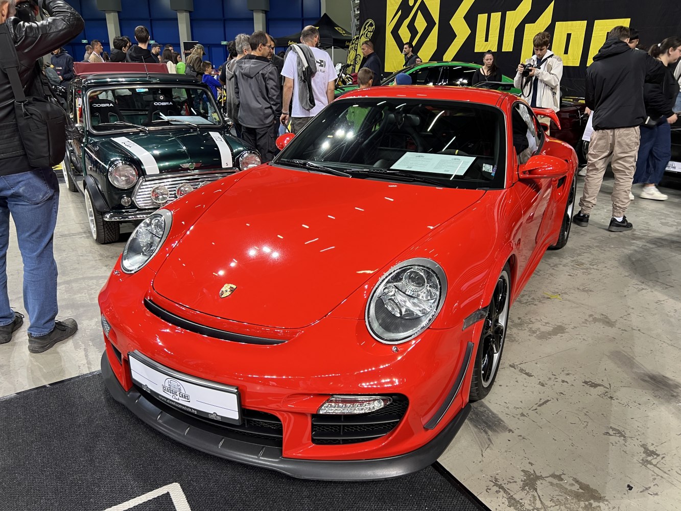 Red Porsche 911 (997) front with round headlights and aerodynamic features