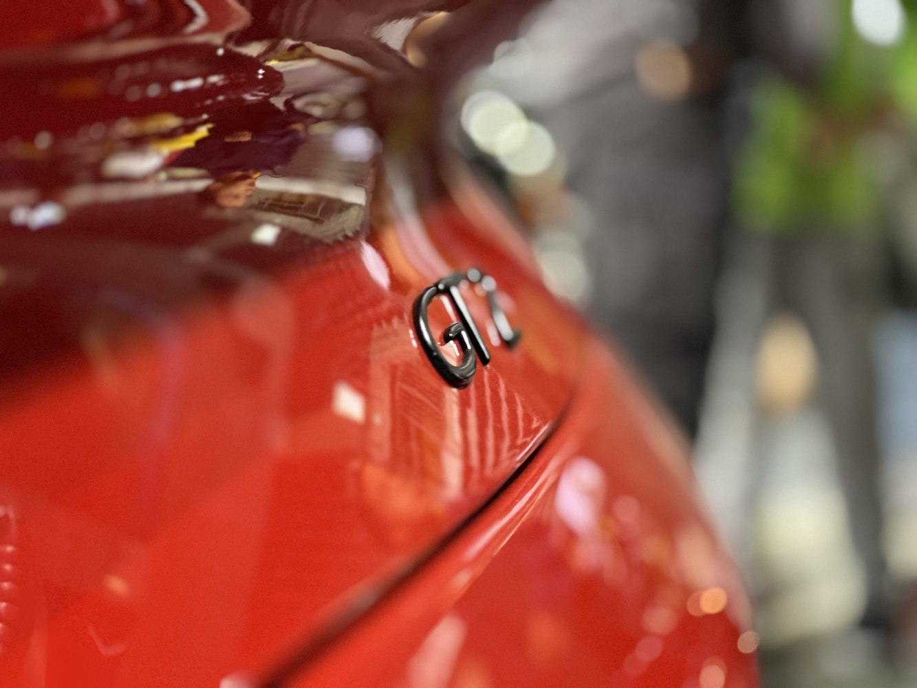 Close-up of GT badge on red curved rear panel