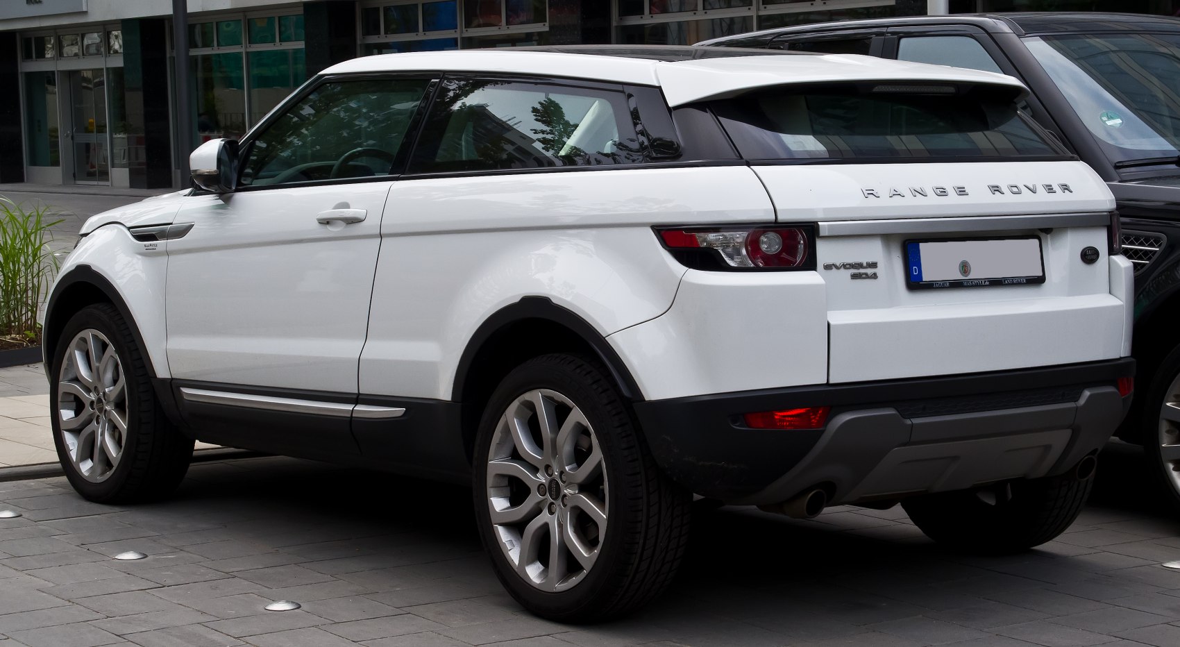 White SUV rear side view with distinctive alloy wheels and rear light cluster