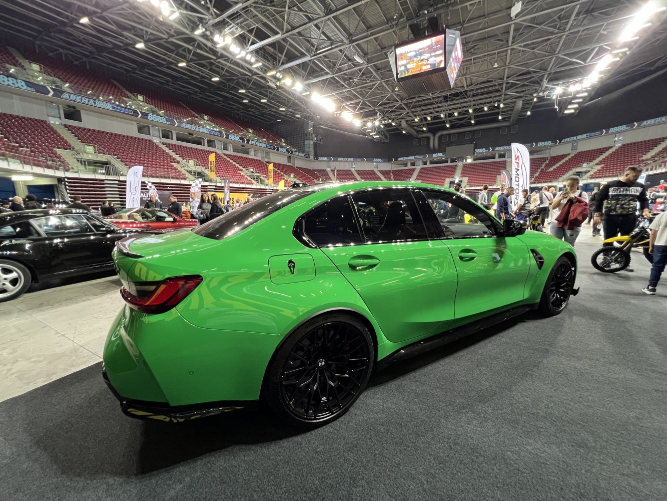 Vibrant sports sedan with black alloy wheels and aggressive design