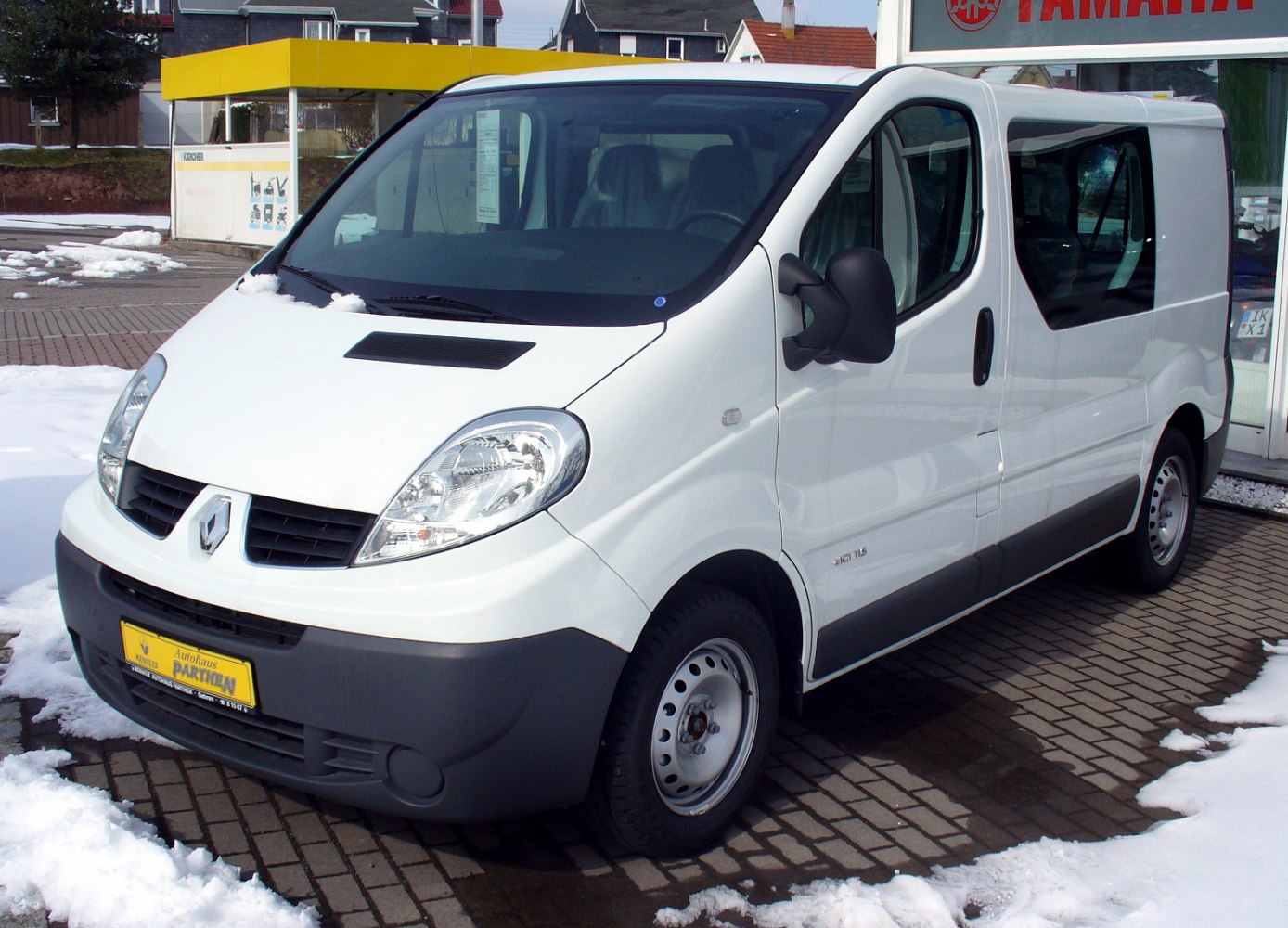 White van with black bumper, metallic wheels, and large headlights