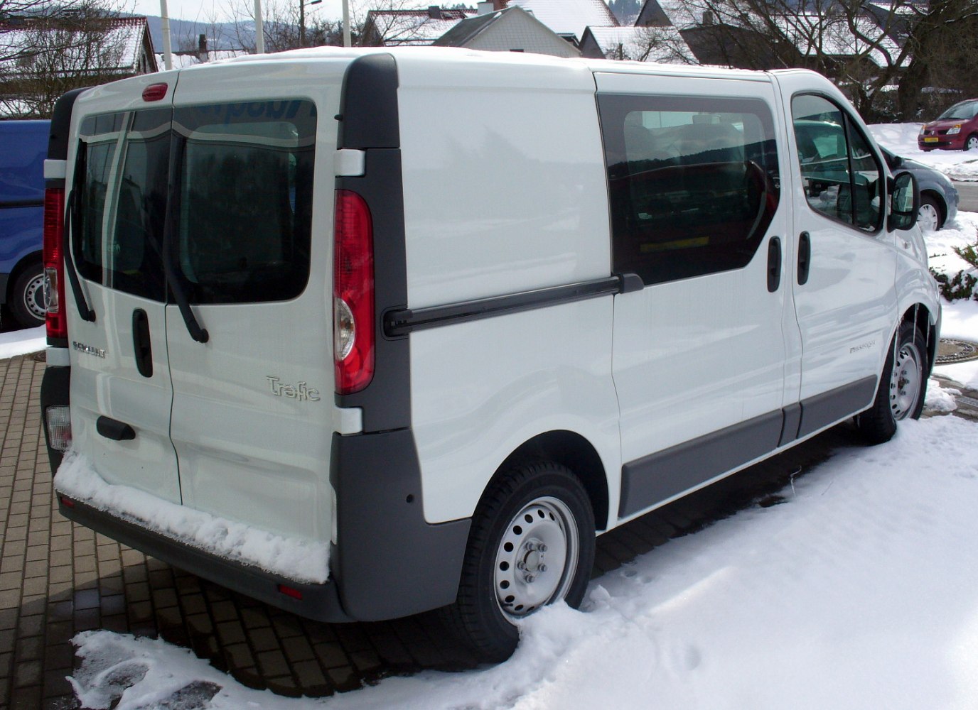 Rear and side view of white commercial van with sliding door