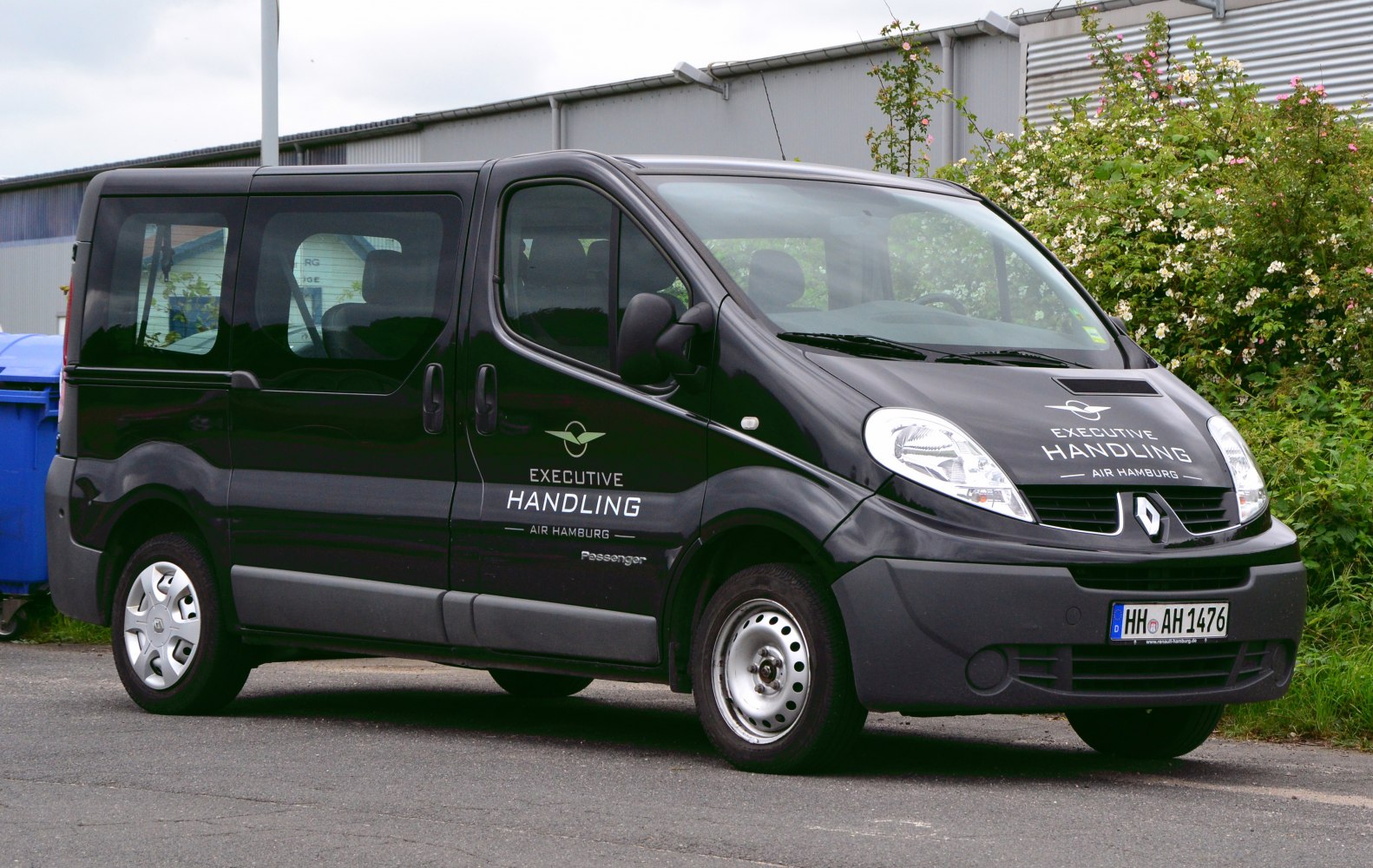 Black passenger van with sliding side door and large windows