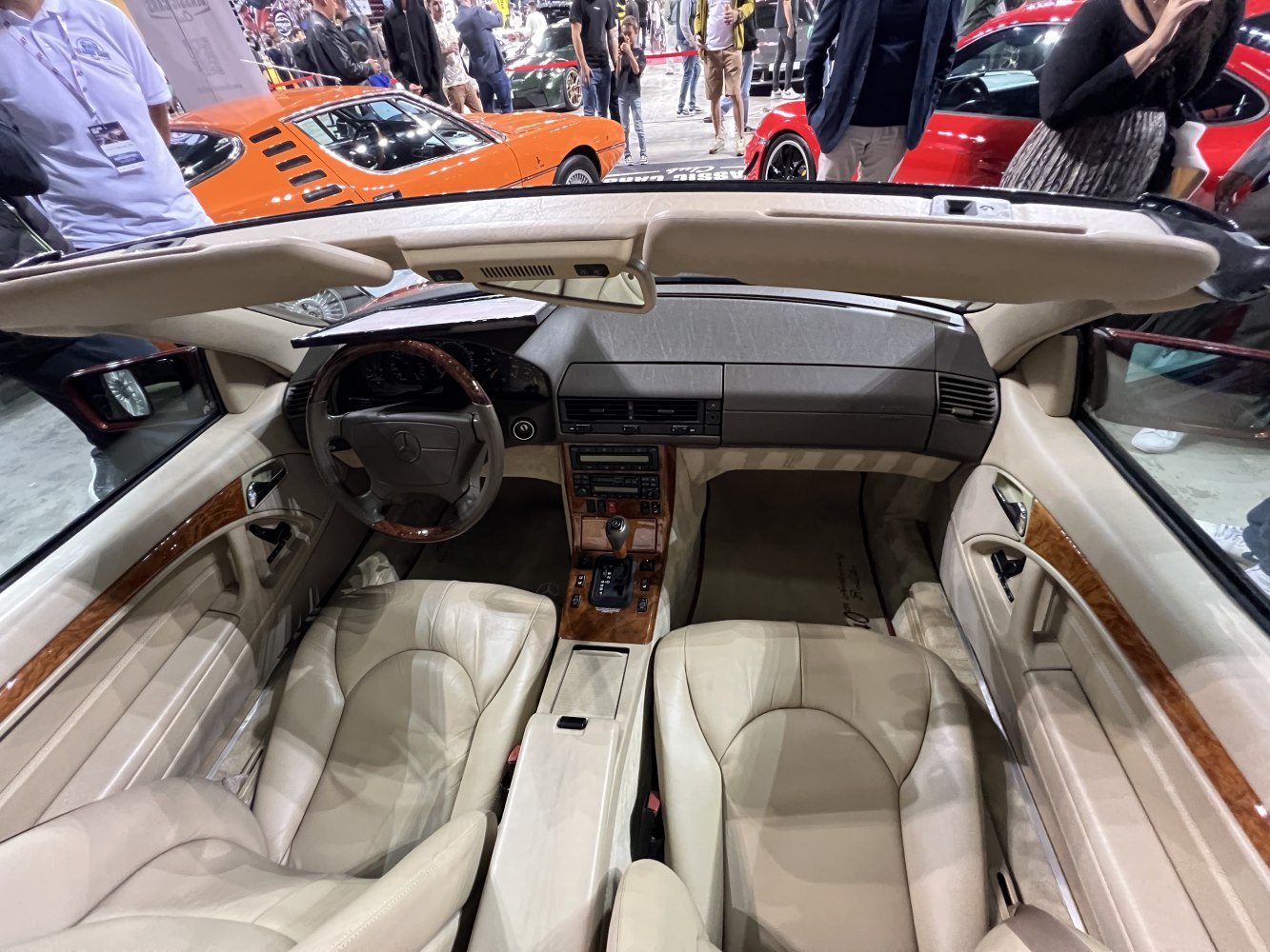 Beige leather interior with wood trim and dashboard view