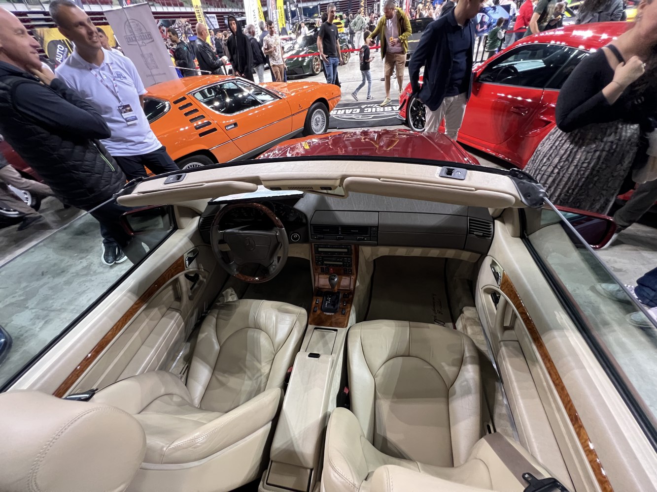 Beige leather convertible interior with wood trim and classic dashboard.