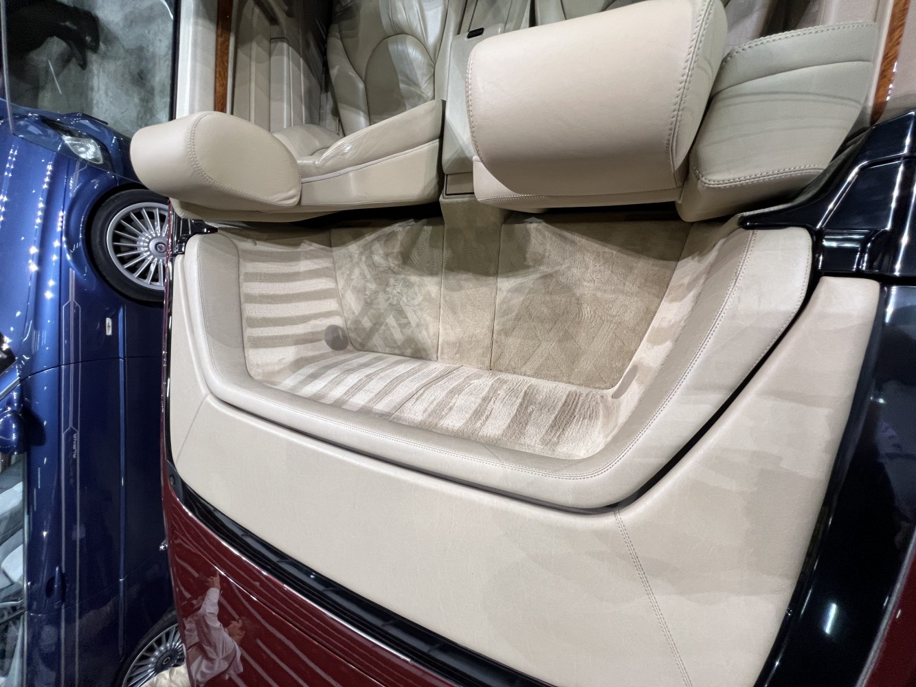 Beige leather interior of convertible with plush carpeting
