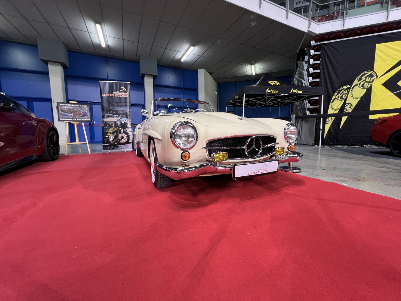Front view of a vintage convertible with distinctive grille and round headlights.