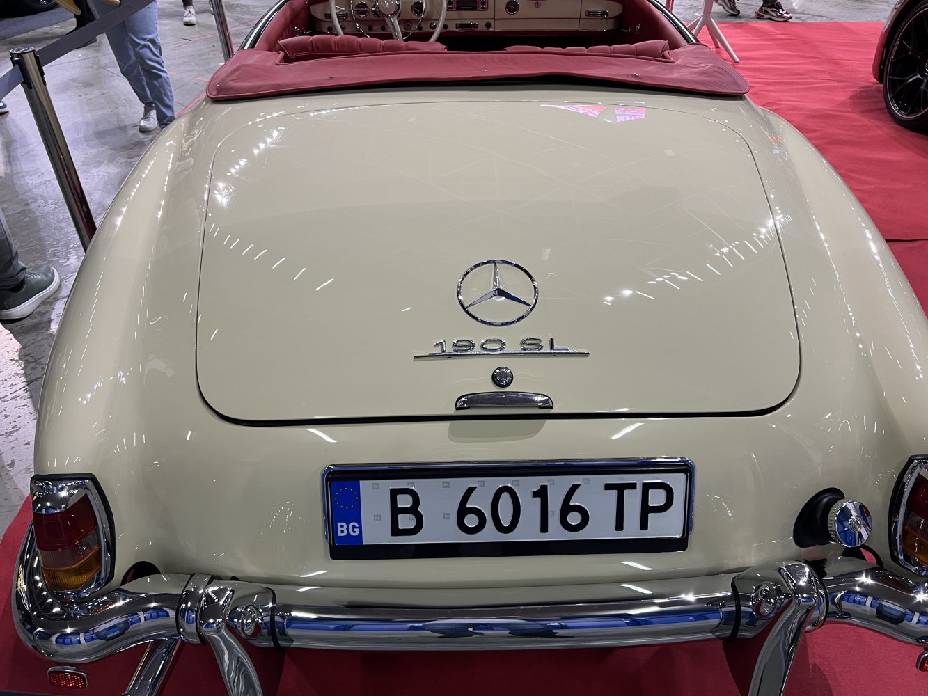 Rear view of a vintage roadster with chrome bumper and classic taillights