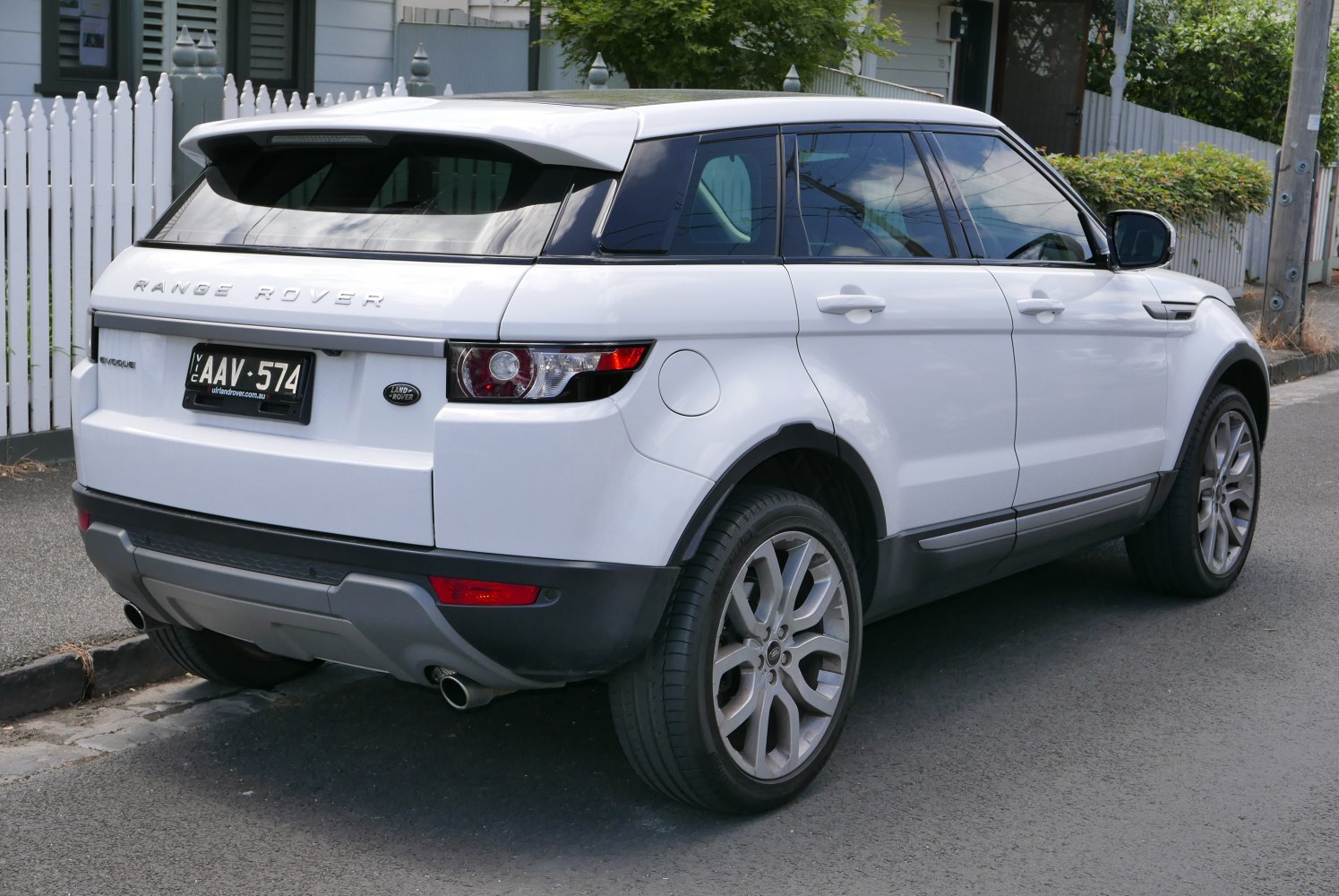 White SUV rear view with distinctive tail lights and tinted rear windows