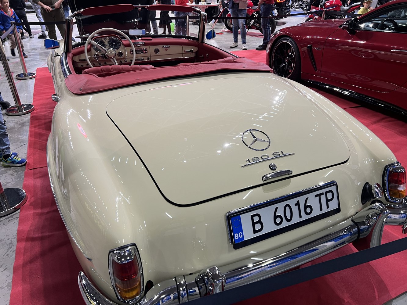 Rear view and interior of vintage convertible with red upholstery