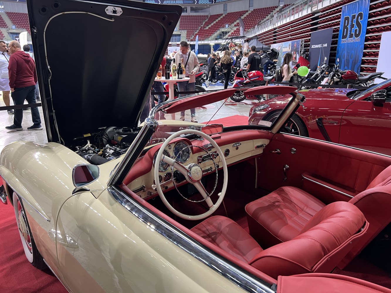 Convertible vintage car interior with open hood revealing engine