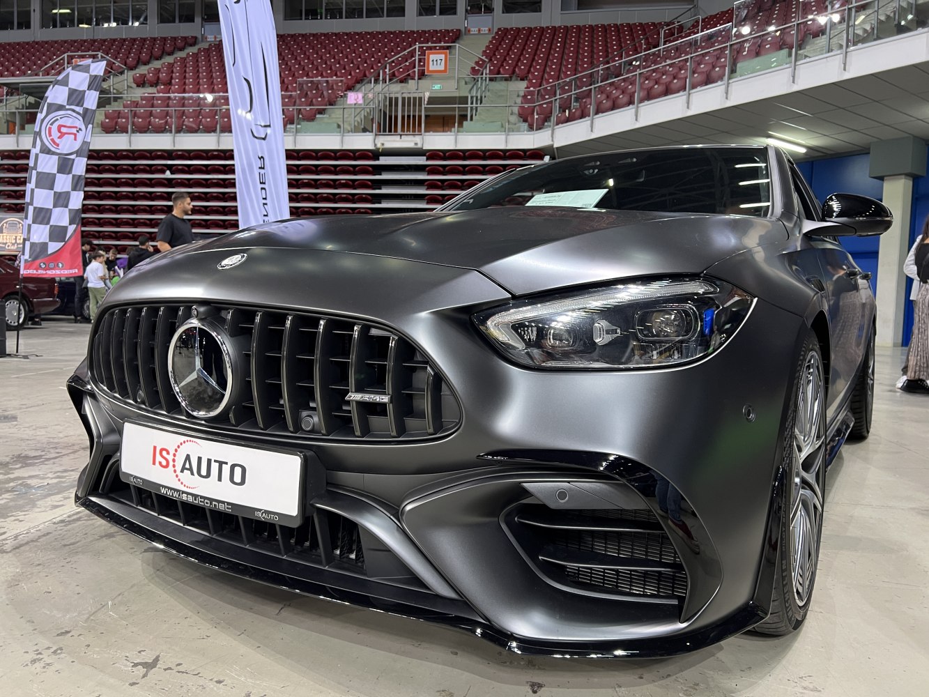Close-up of front grille and headlight with sporty, aggressive design.