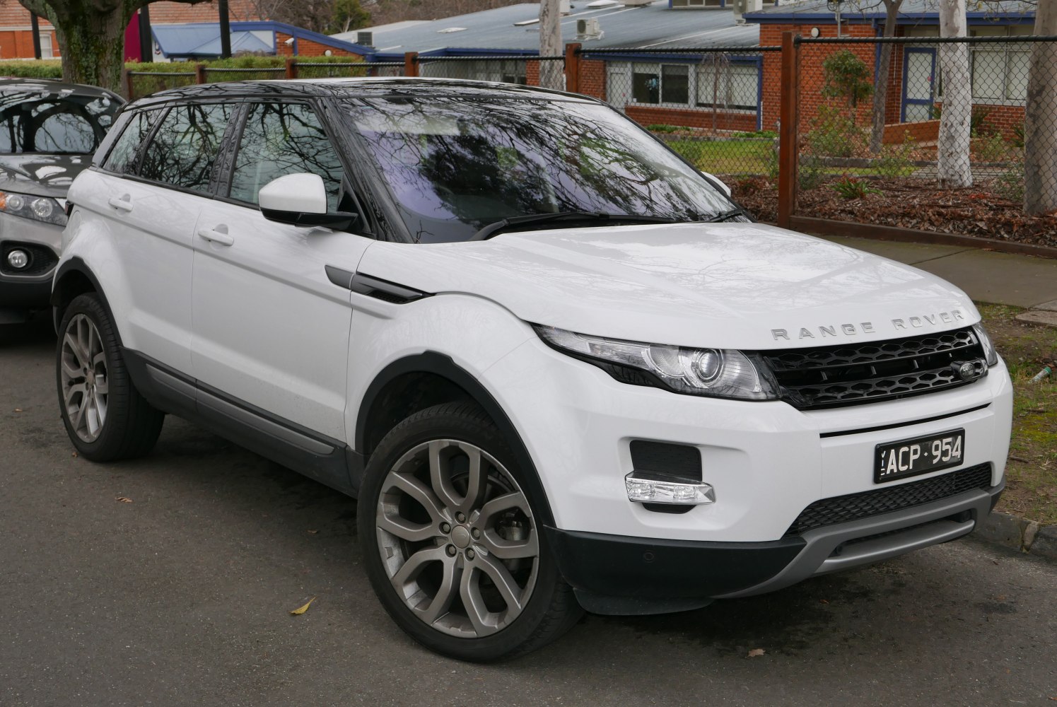 Front and side view of a white compact SUV with distinctive LED headlights and alloy wheels