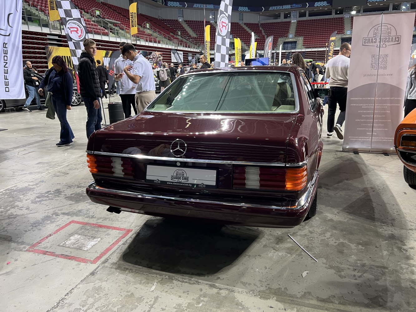 Rear view of classic coupe with distinctive tail lights and emblem