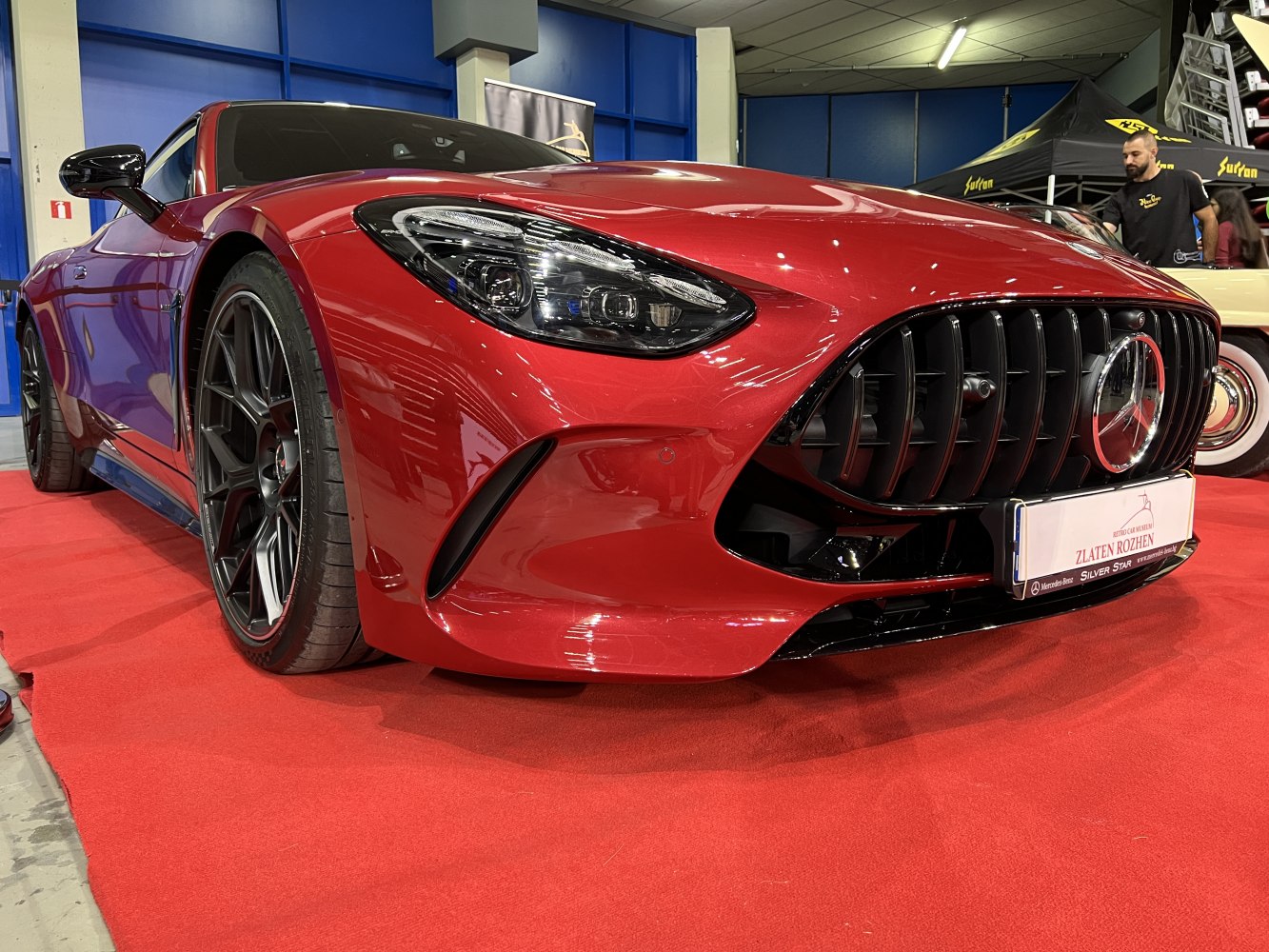 Aggressive front grille and sleek headlights on red sports coupe