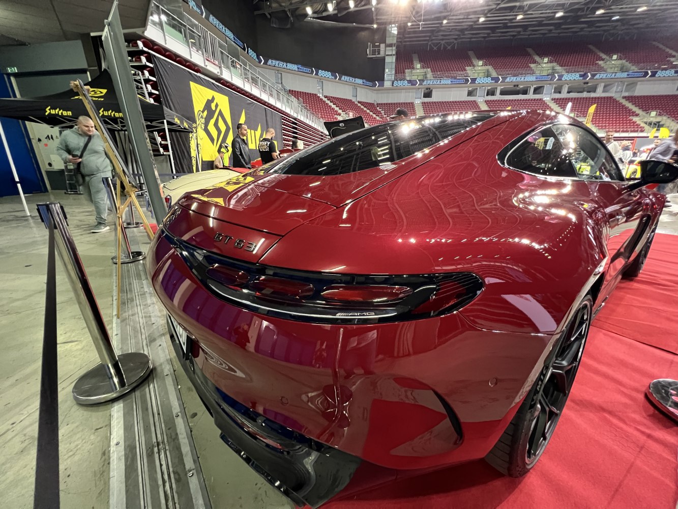 Rear view showing GT 63 badge and sleek LED taillights on a glossy red sports coupe