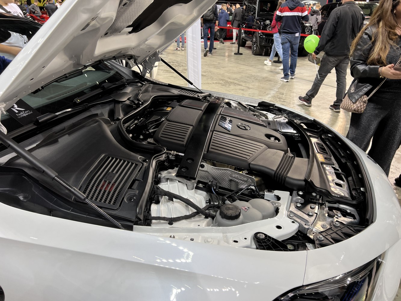 Open hood view showing detailed Mercedes-Benz coupe engine bay.