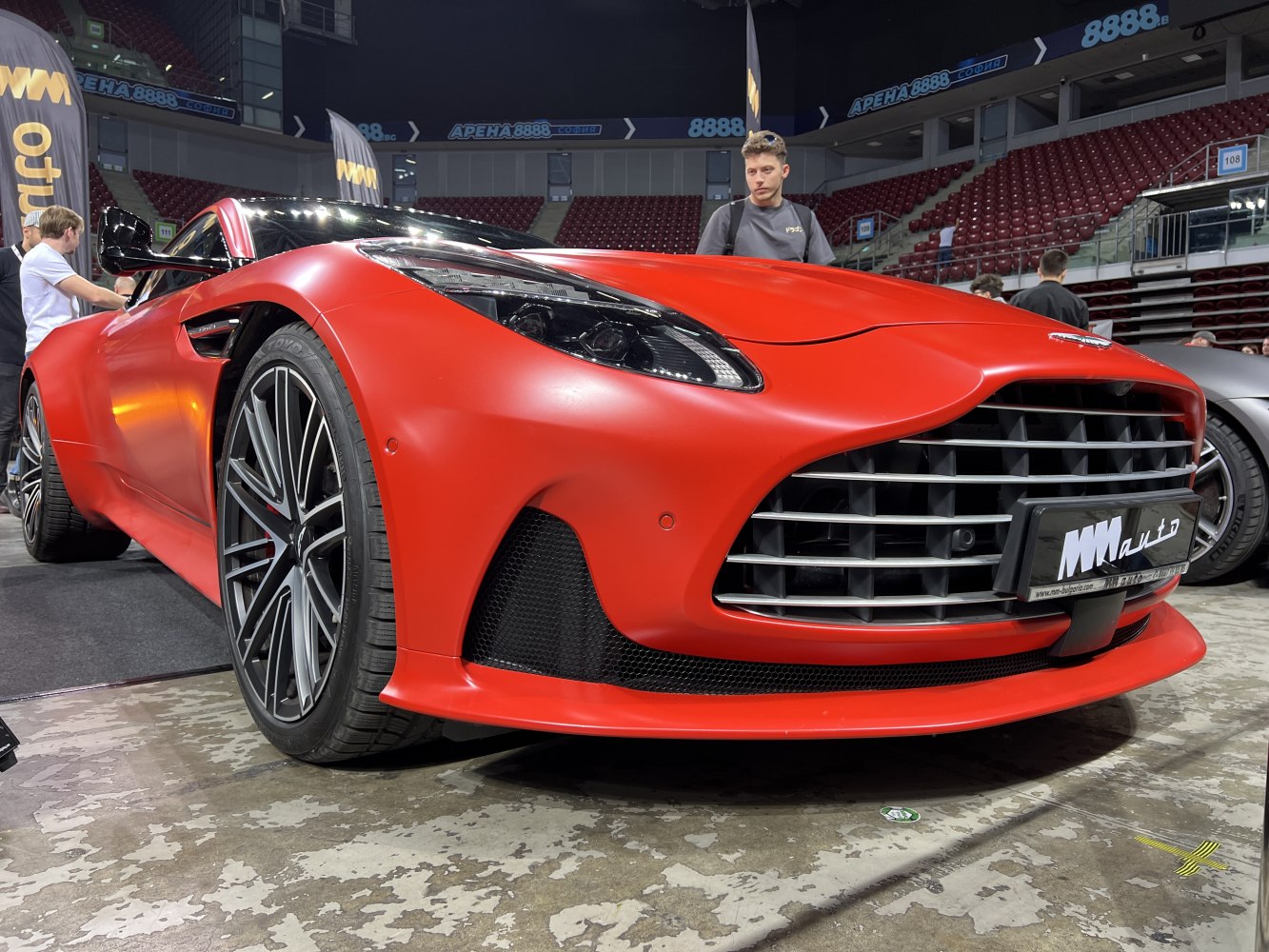 Matte red front grille and headlight of a modern luxury coupe