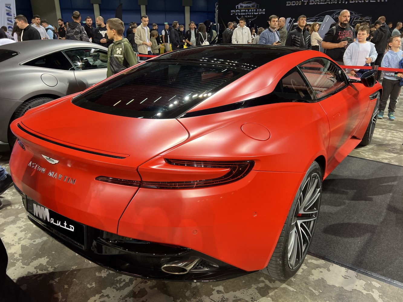 Sporty rear view of red matte finish luxury coupe with sleek taillights and alloy wheels