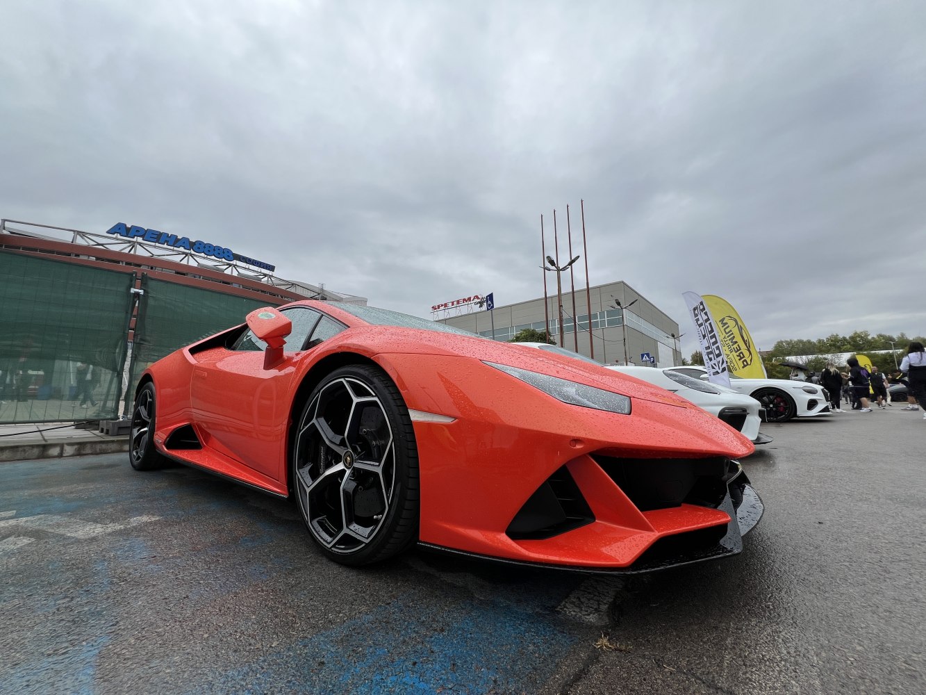 Front and side perspective of a sporty coupe with aggressive design and unique wheels.