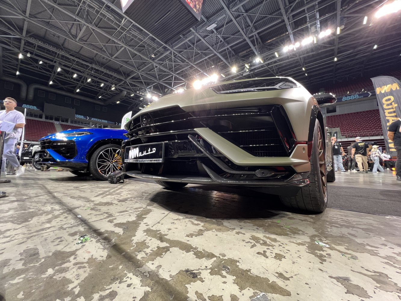 Close-up of front grille and sporty wheel design with aggressive bumper lines