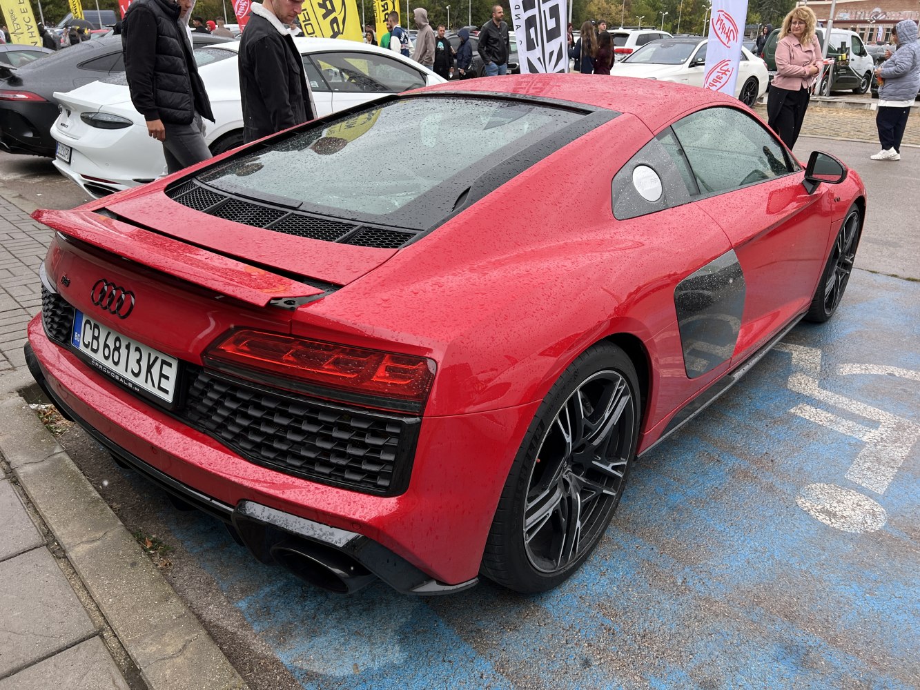 Red sports coupe rear view with spoiler and black alloy wheels