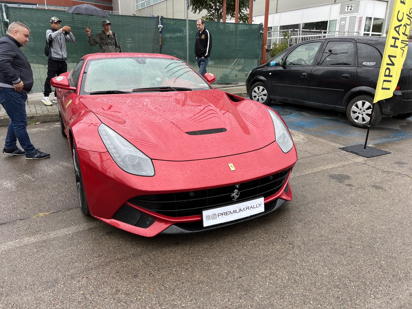 Front view of red sports car with sleek headlights and hood vent