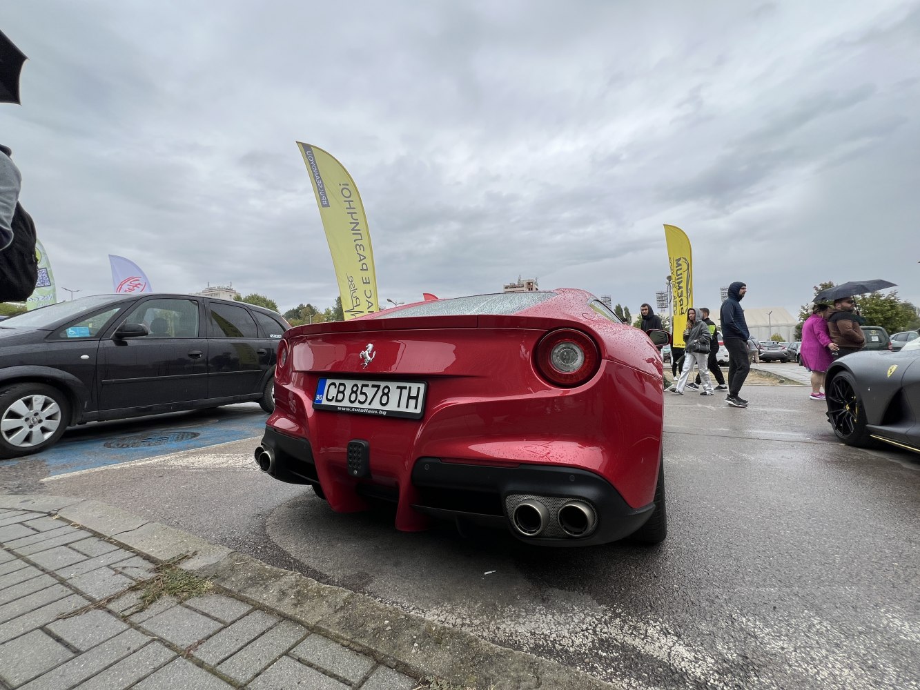 Rear view of red sports car with dual exhaust and round taillights