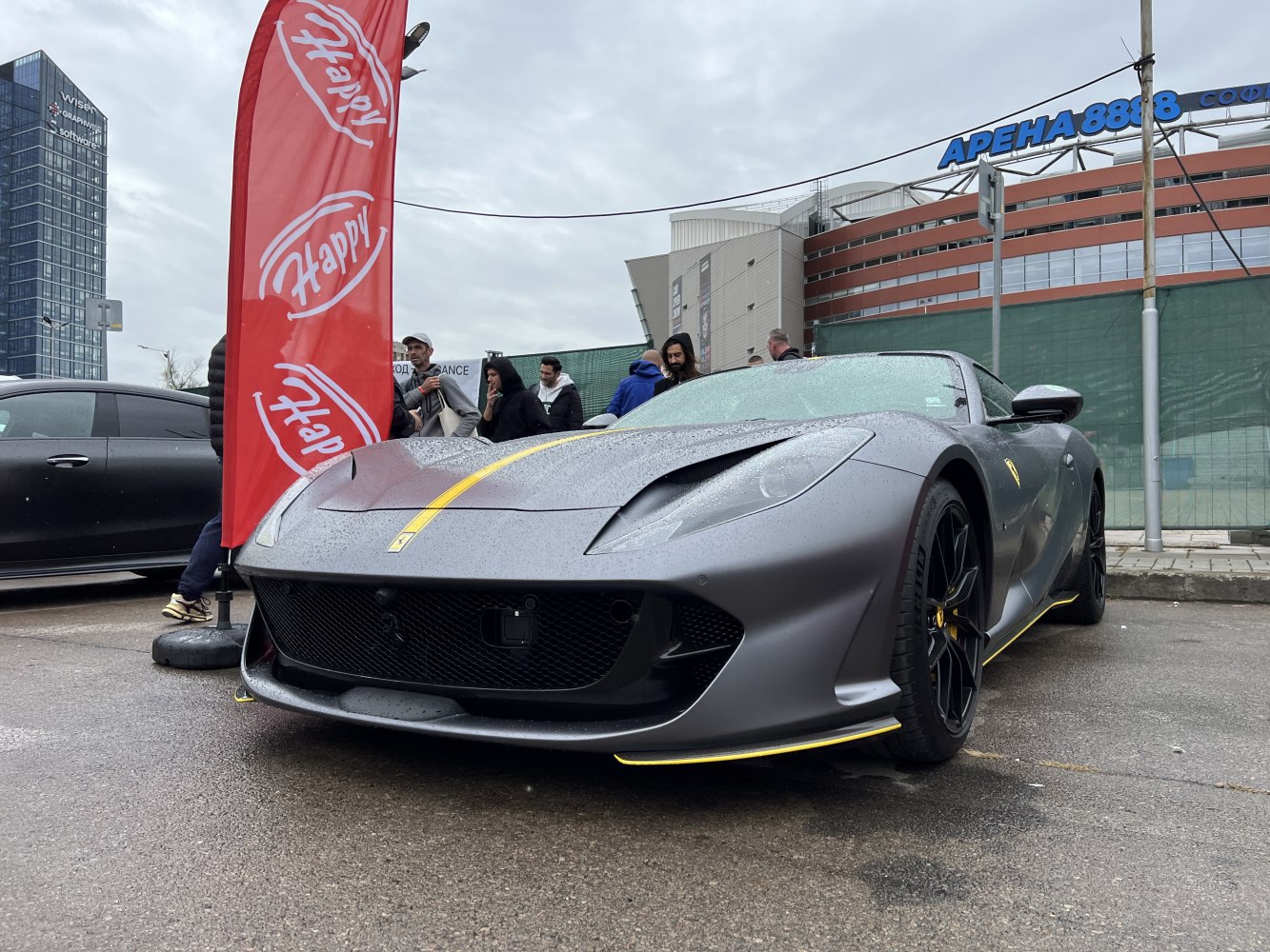 Matte gray supercar front with yellow racing stripes and black wheels