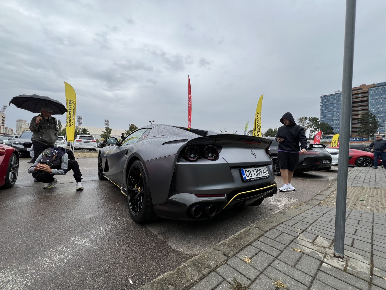 Rear view of a matte silver supercar with quad exhausts and black wheels
