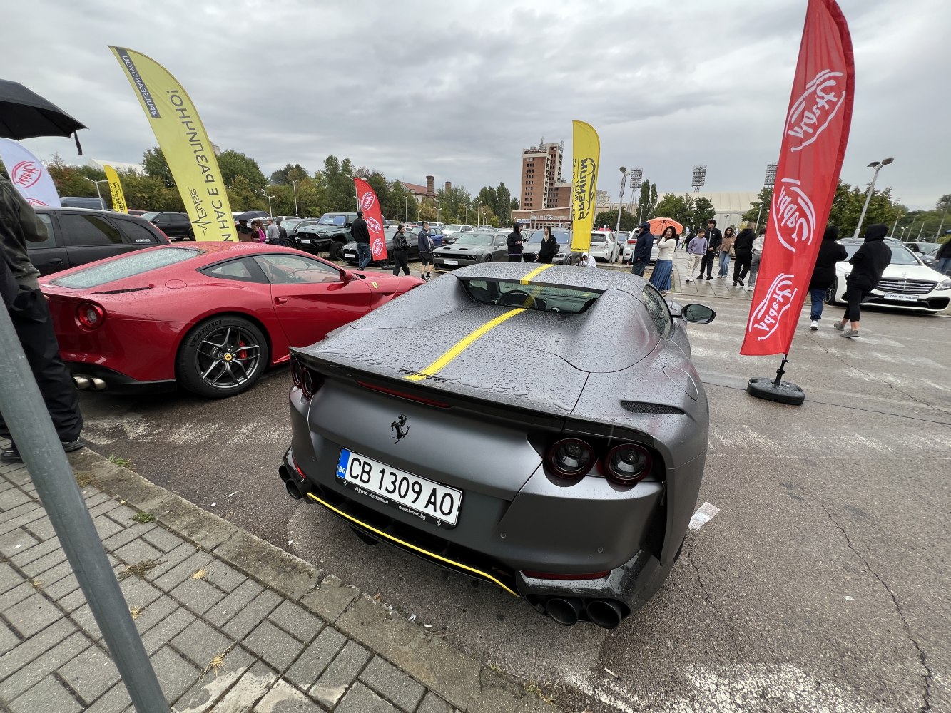 Rainy rear view of Ferrari 812 Superfast with yellow stripe and round tail lights