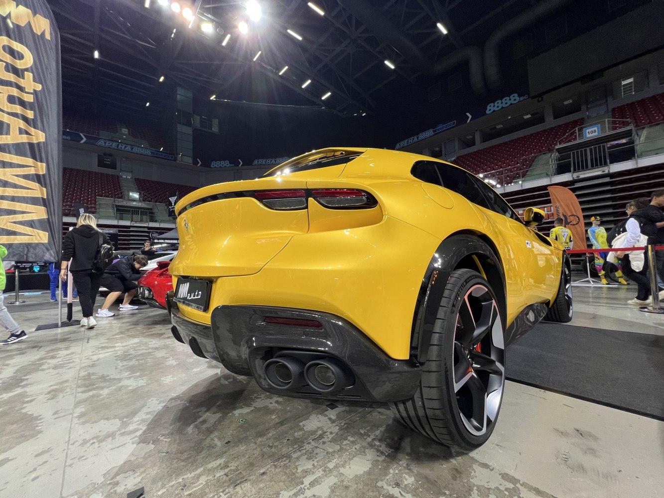 Yellow SUV rear view with quad exhaust and sporty wheels