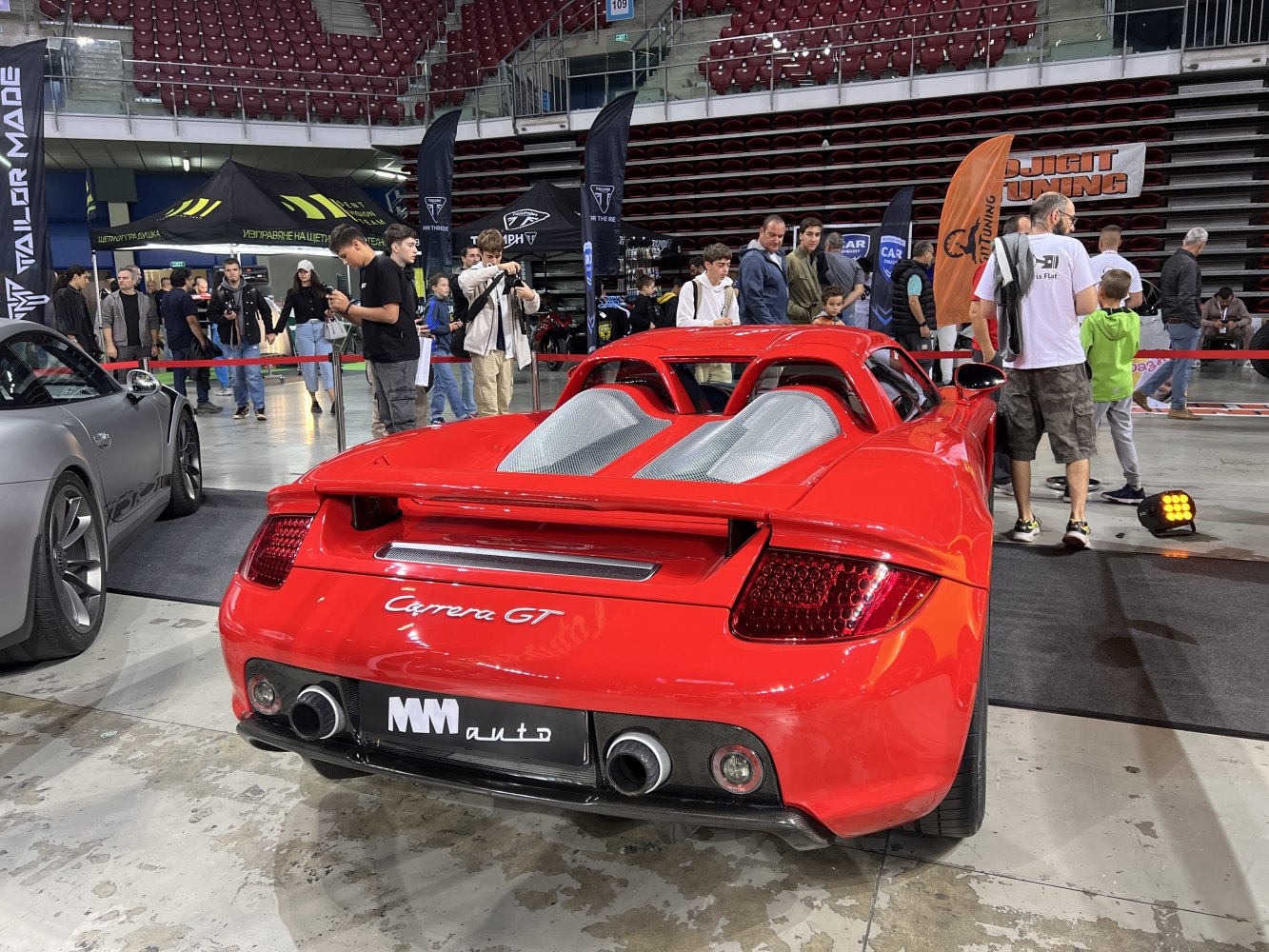 Rear with dual exhausts and engine bay vents of a red sports car
