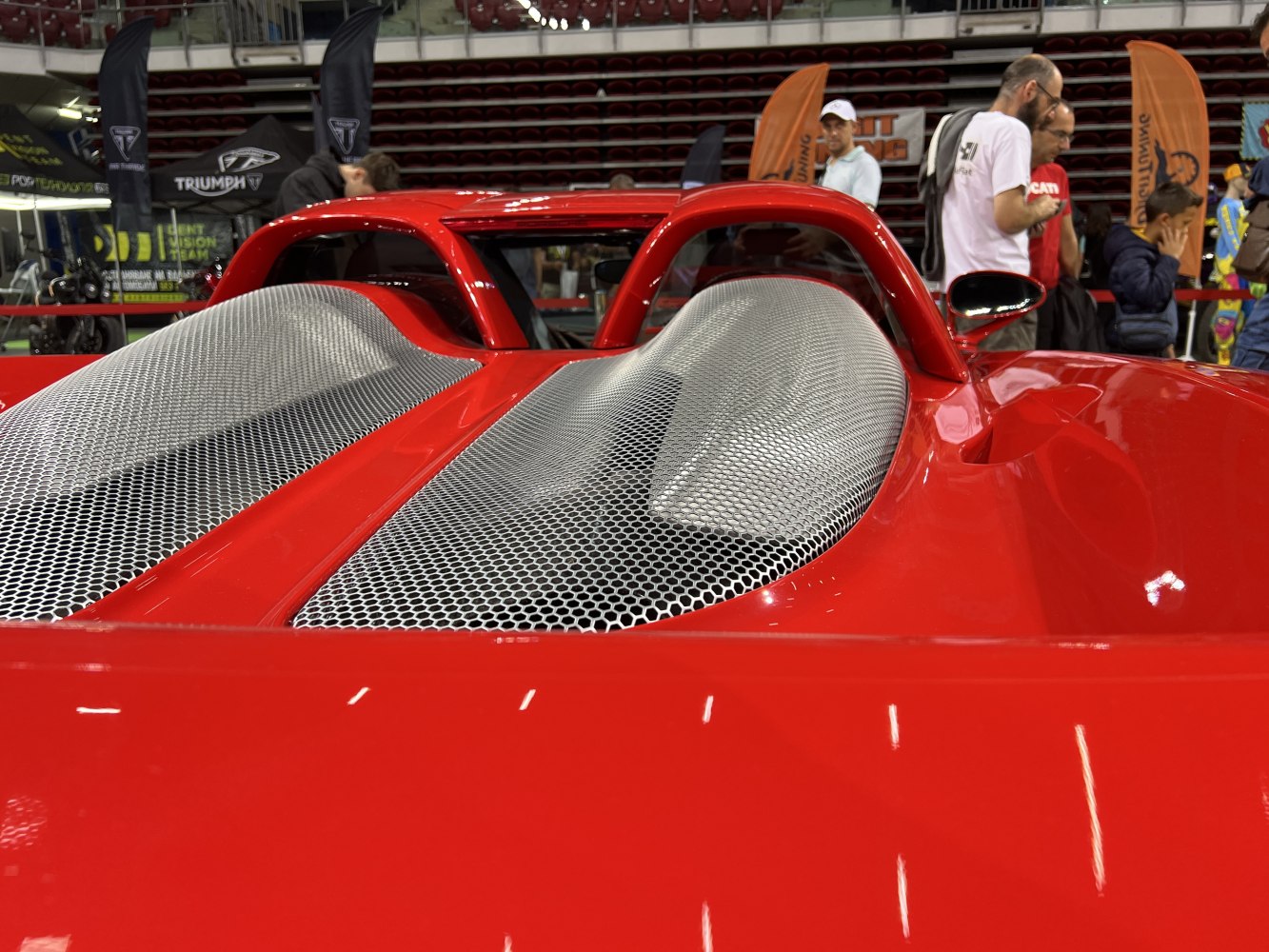Rear engine cover and roll bars with mesh vents on red sports car