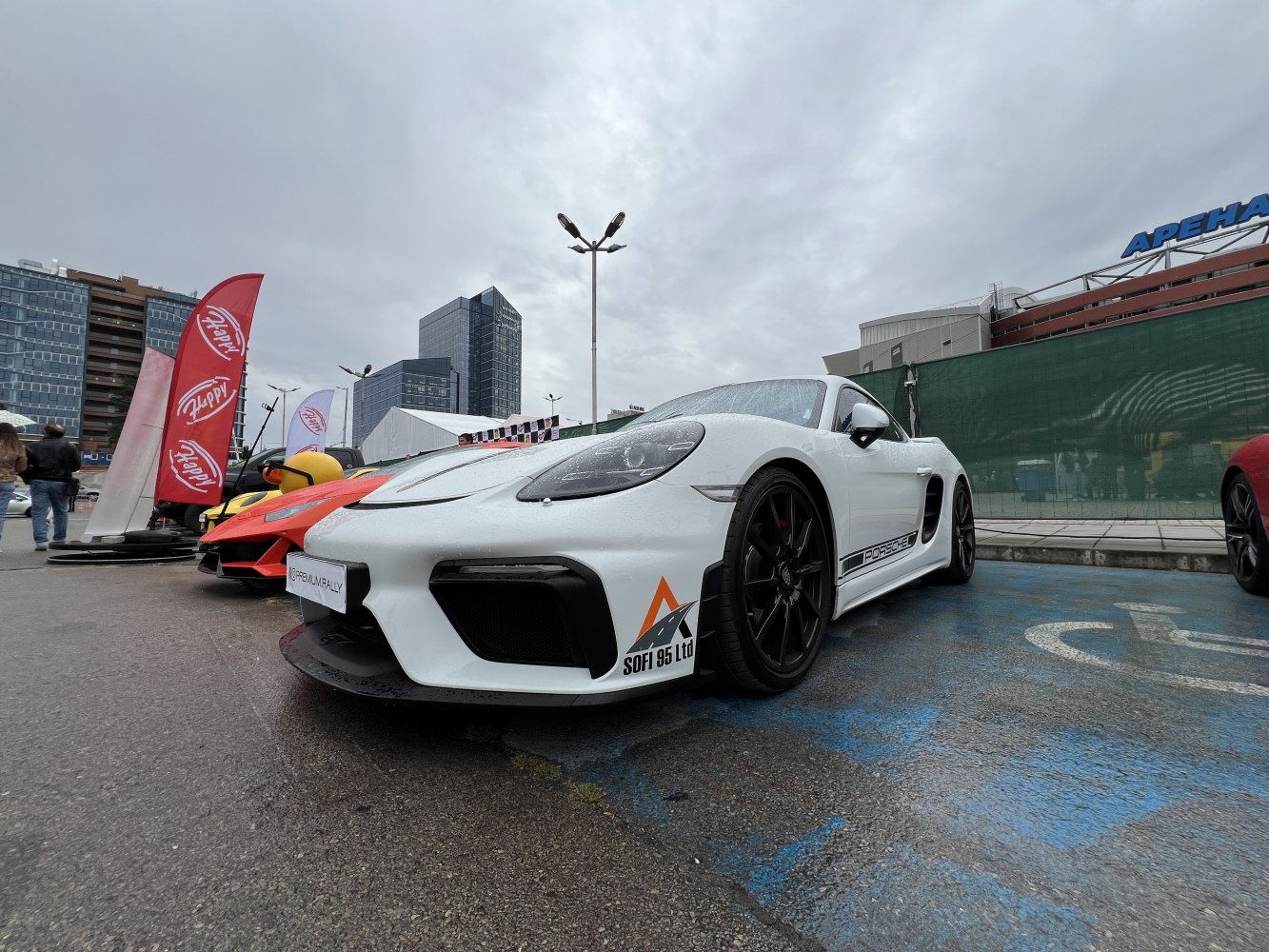 White sports coupe with aerodynamic front and black alloy wheels.