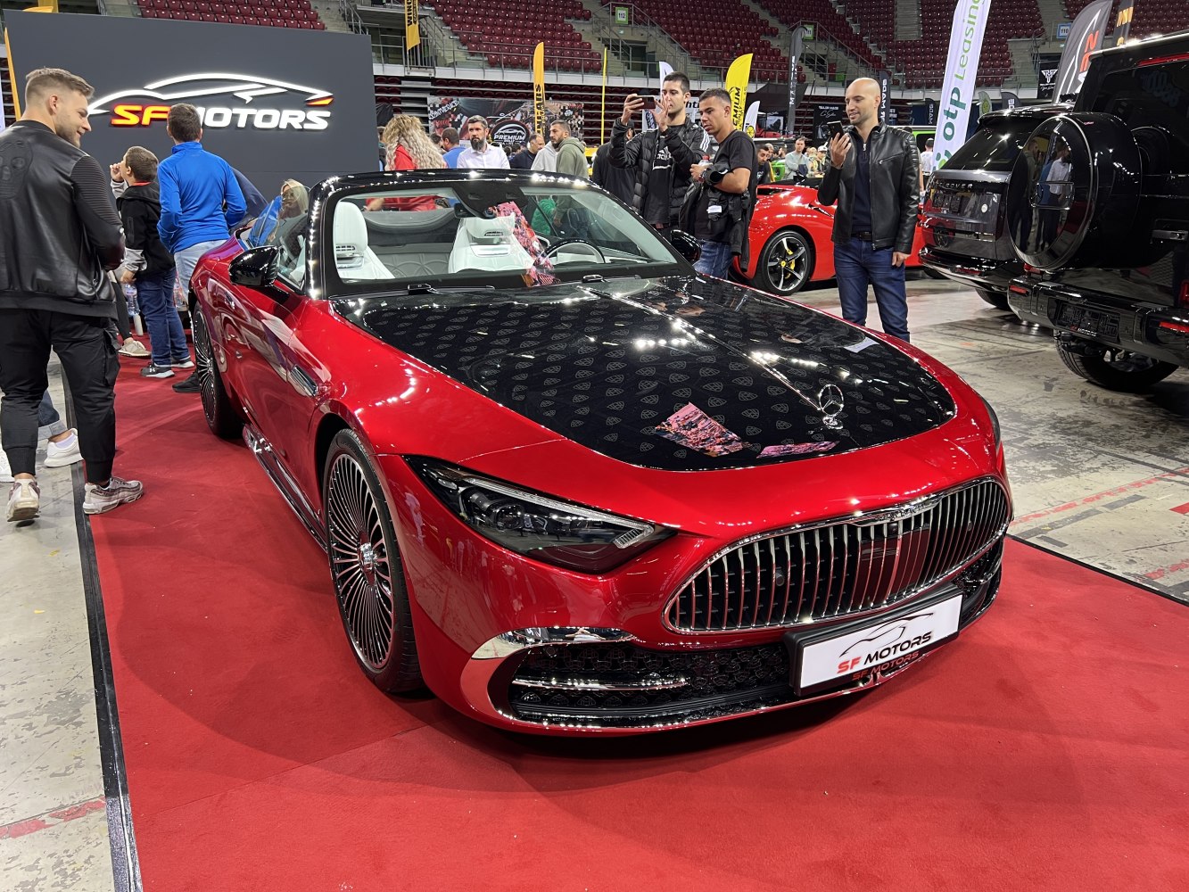 Luxury convertible with distinctive black hood and prominent front grille.