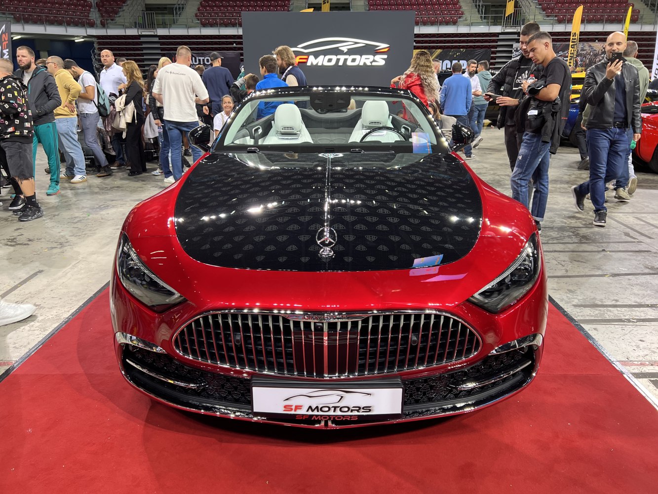 Luxury convertible front view with black hood and premium grille