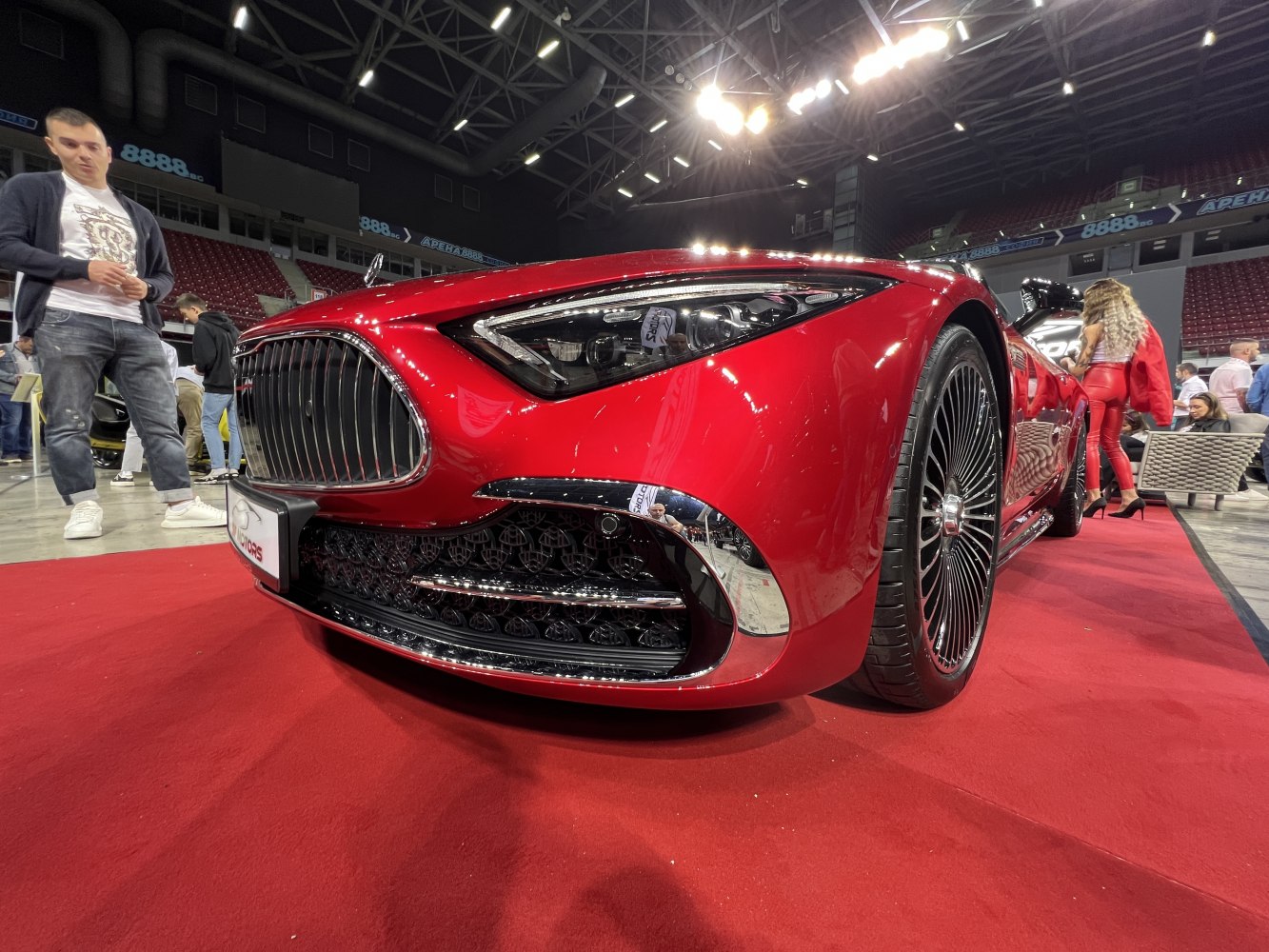 Close-up of front grille, headlight and wheel of luxury car