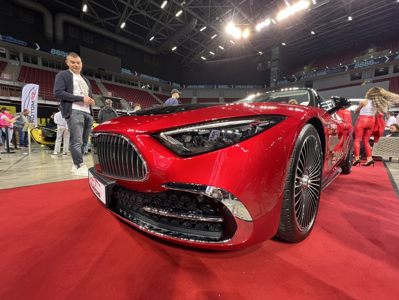 Close-up of front grille and headlight of a luxury sports coupe.