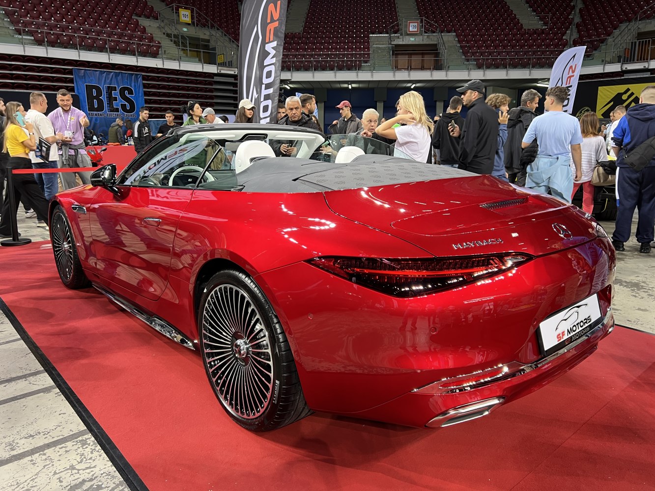 Luxury red convertible rear with convertible soft top and distinctive taillights