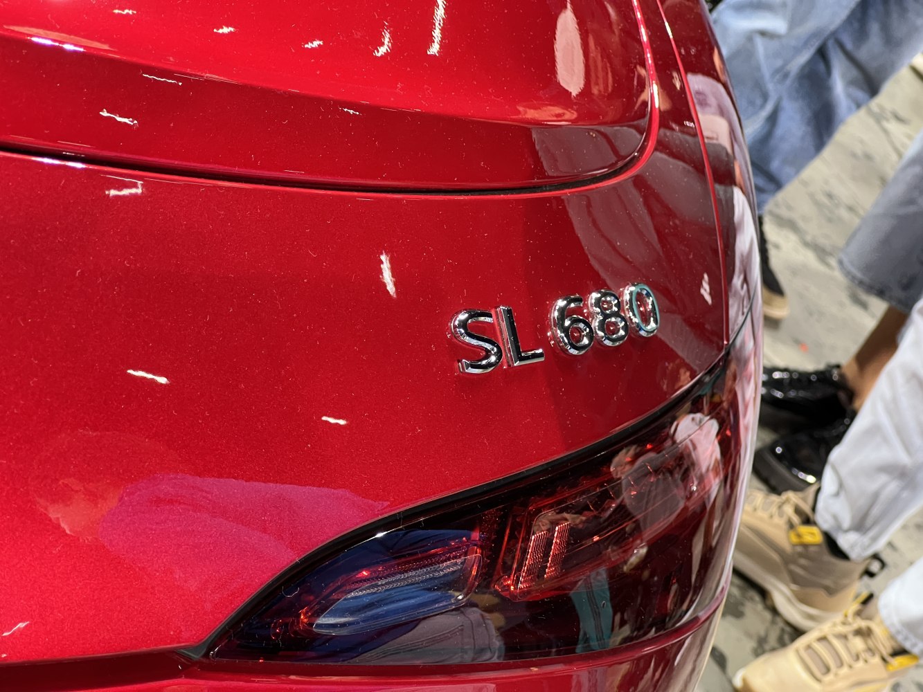 Close-up of SL 680 badge and rear tail light on red luxury coupe