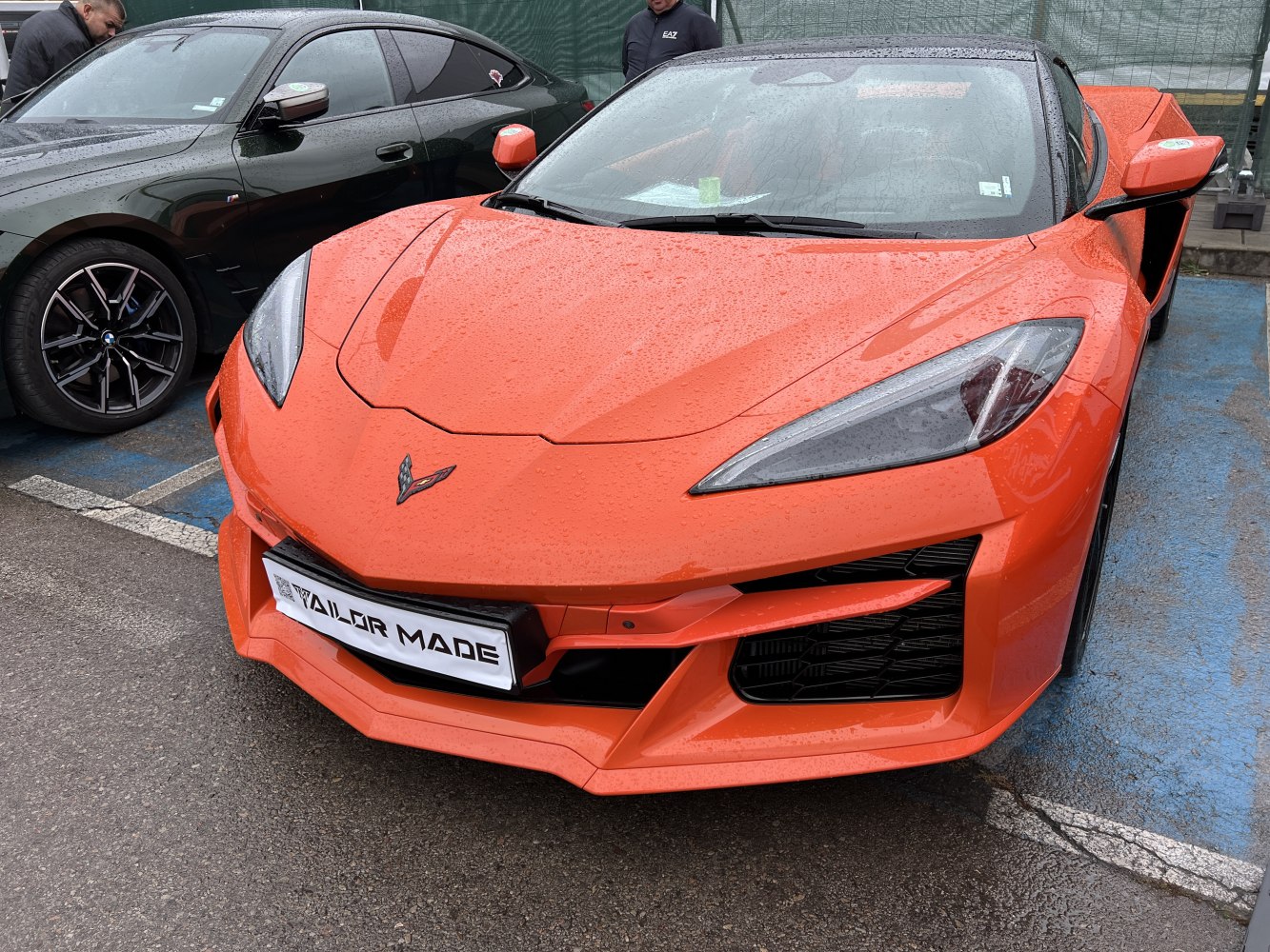 Front end with sharp headlights and aerodynamic features on an orange sports coupe