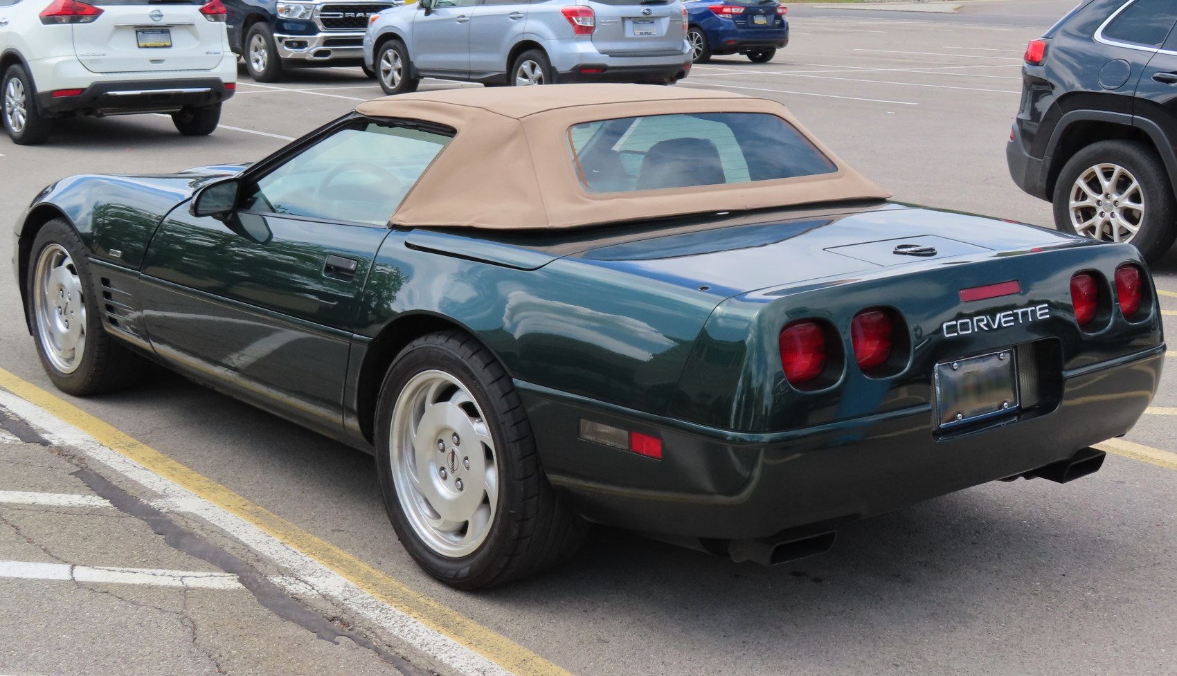 Convertible with beige soft top and quad circular tail lights